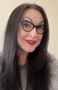 An image of a woman smiling at the camera.