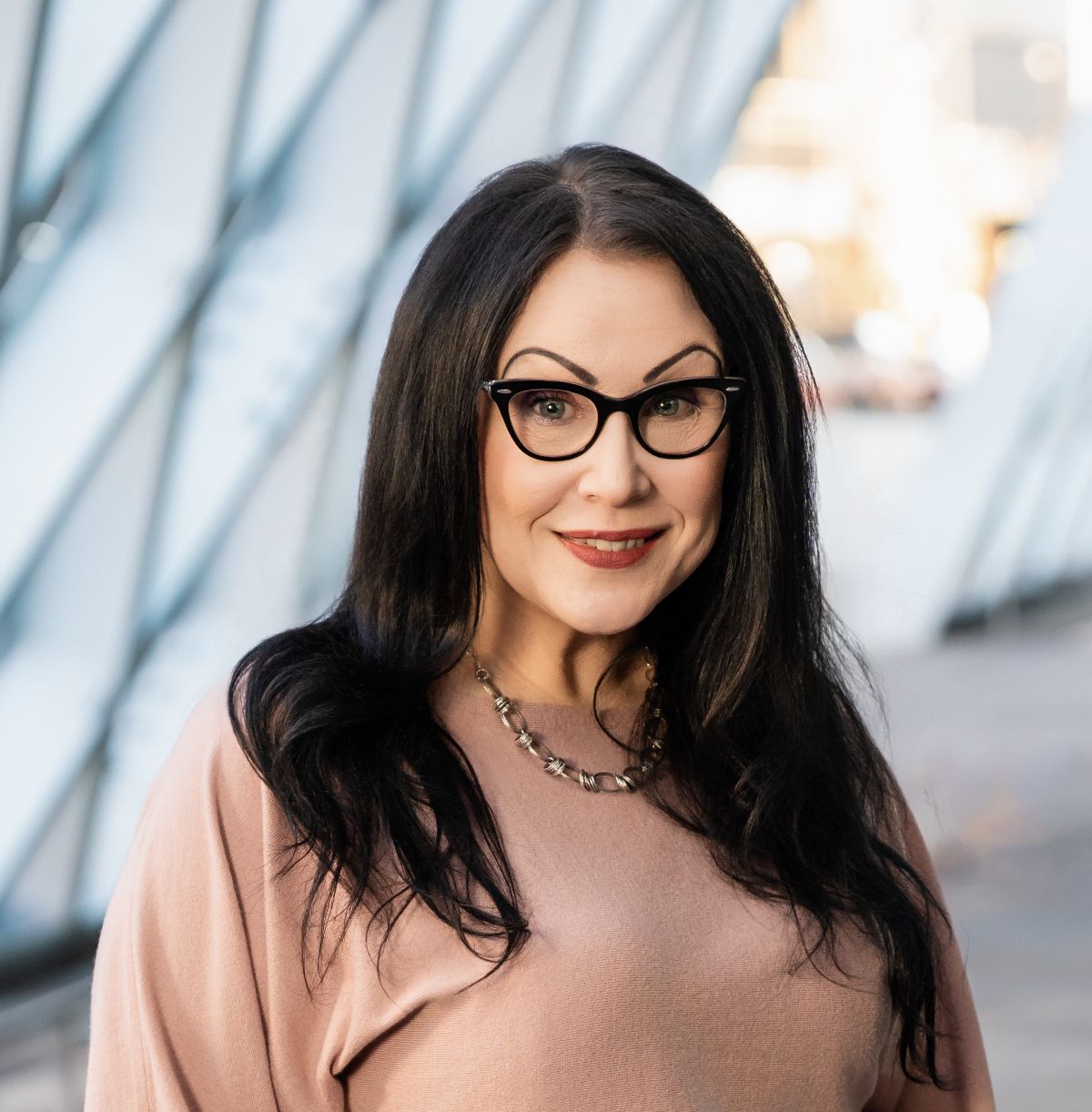 A woman posing for a headshot photo.